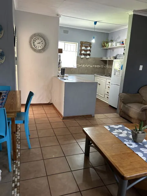 Openplan kitchen and living area with tiled floors and modern decor