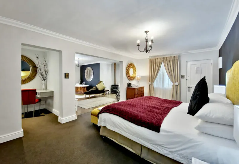 Modern hotel room with a large bed seating area and elegant decor