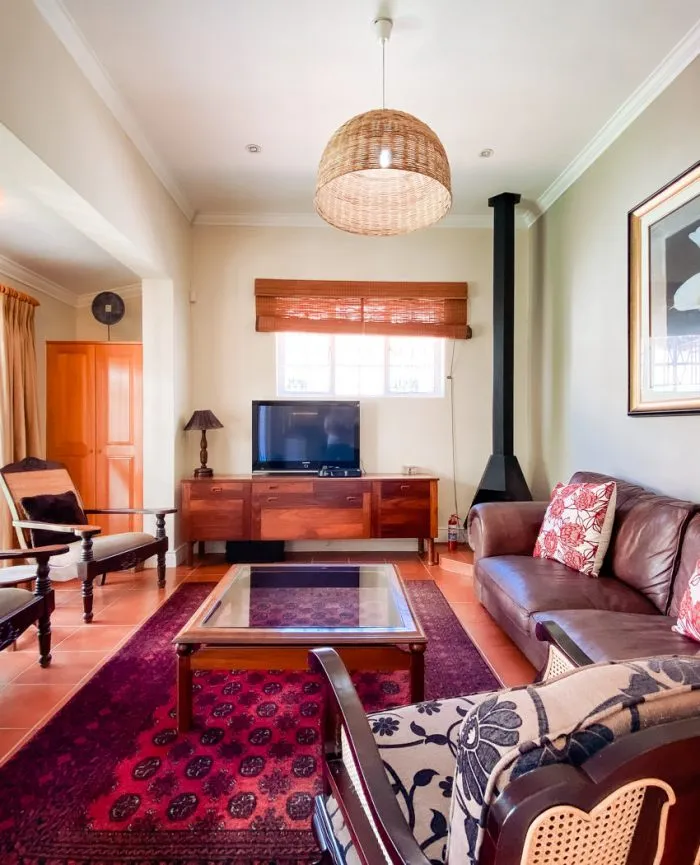 Cozy living room with wooden furniture TV and patterned rug