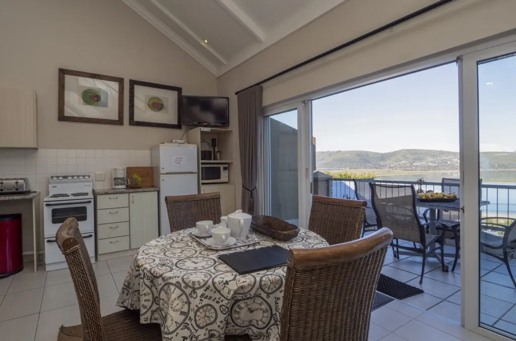 Kitchen with dining table chairs and a view of hills through sliding doors
