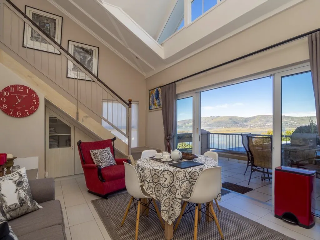 Modern living room with dining area large windows and mountain view