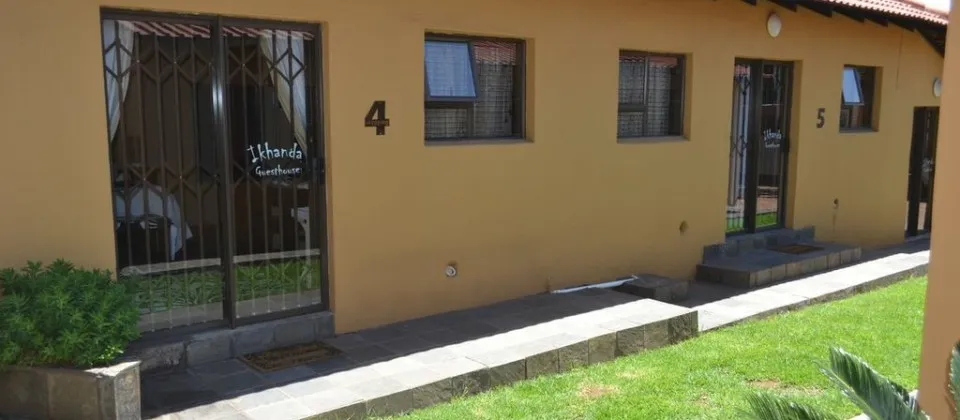 Row of yellow buildings with numbers 4 and 5 windows and doors