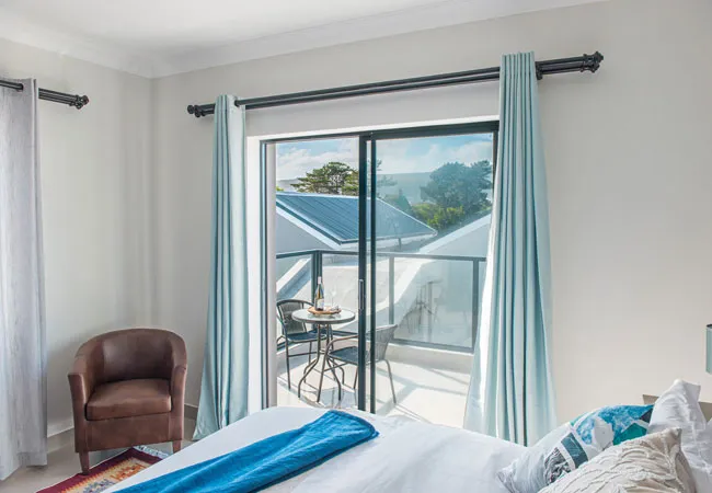 Bedroom with sliding glass door balcony view and armchair