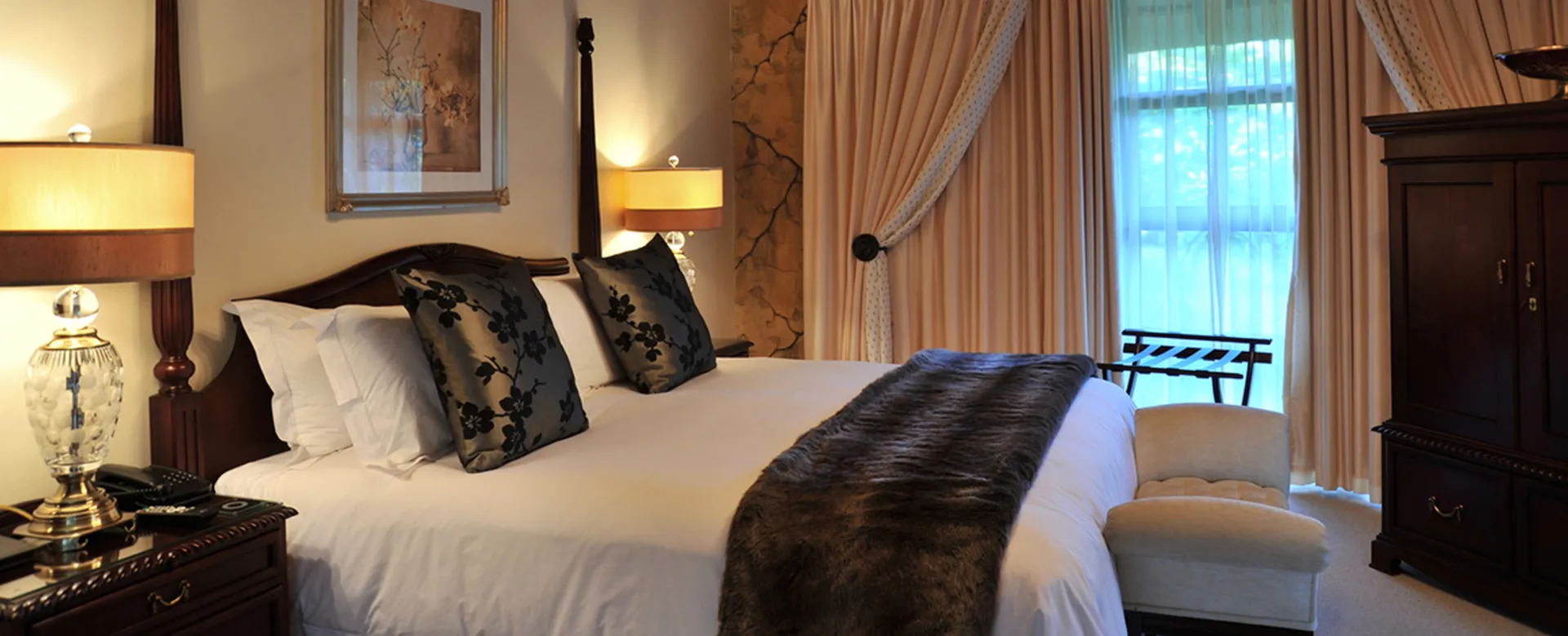 Elegant bedroom with large bed lamps and window with curtains