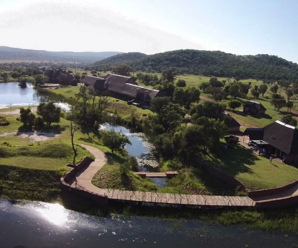 Aerial view of a resort with buildings greenery and water features