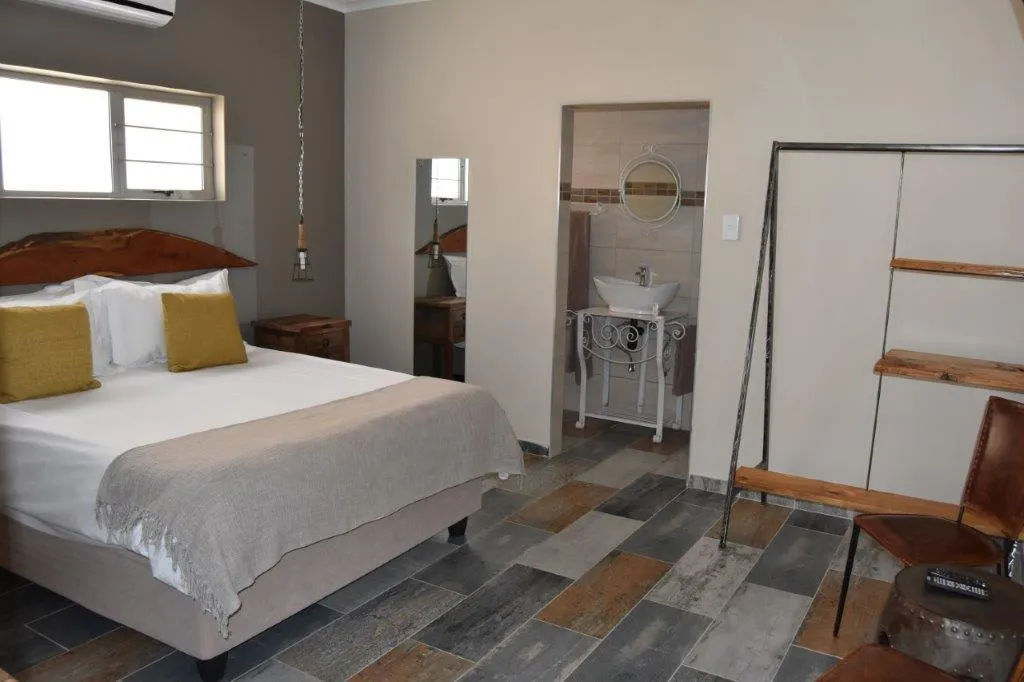 Cozy bedroom with a bed wooden furniture and an attached bathroom