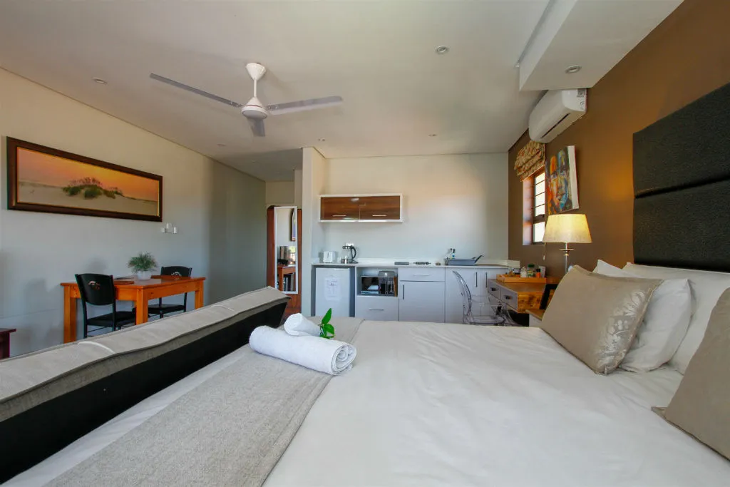 Cozy bedroom with kitchenette ceiling fan and modern decor
