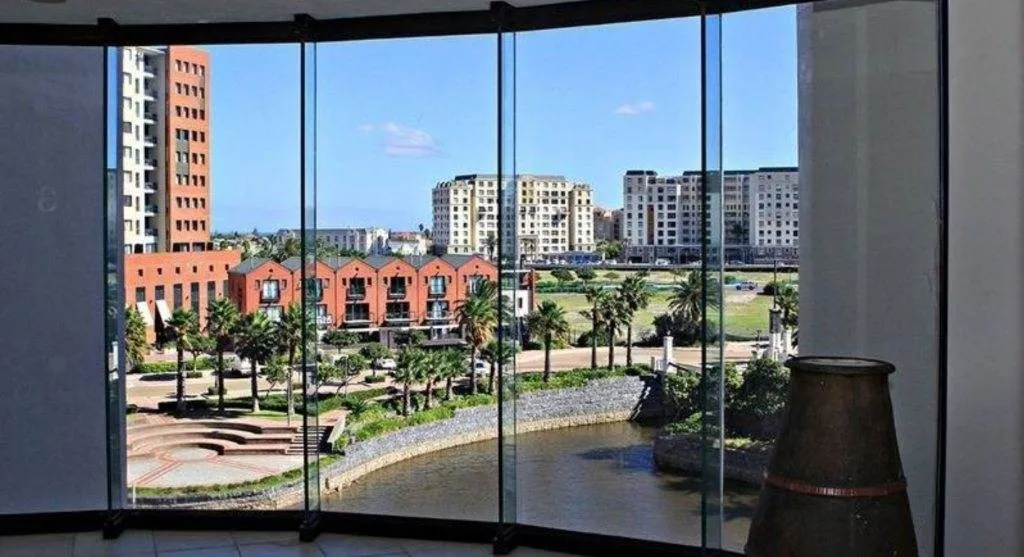 View of modern buildings and palm trees from a large window