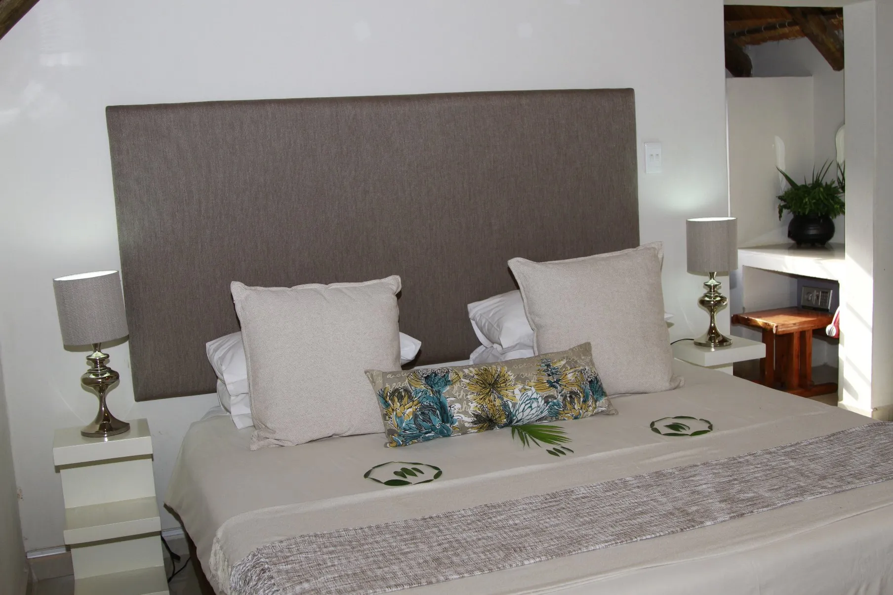 Neatly made bed with pillows and bedside lamps in a bedroom