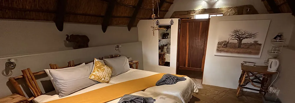 Cozy bedroom with a large bed wooden furniture and African decor
