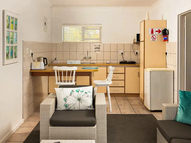 Small kitchenette with seating area tiled walls and a window