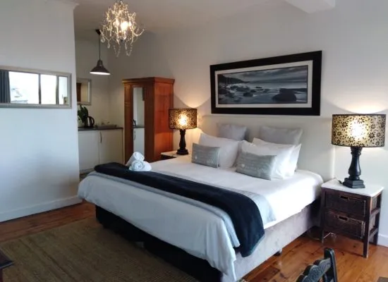 Cozy bedroom with a large bed bedside lamps and a wooden wardrobe