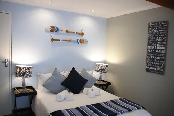 Cozy bedroom with striped bedding wall decor and bedside lamps