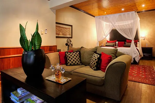 Cozy living room with sofa coffee table and bedroom with canopy bed