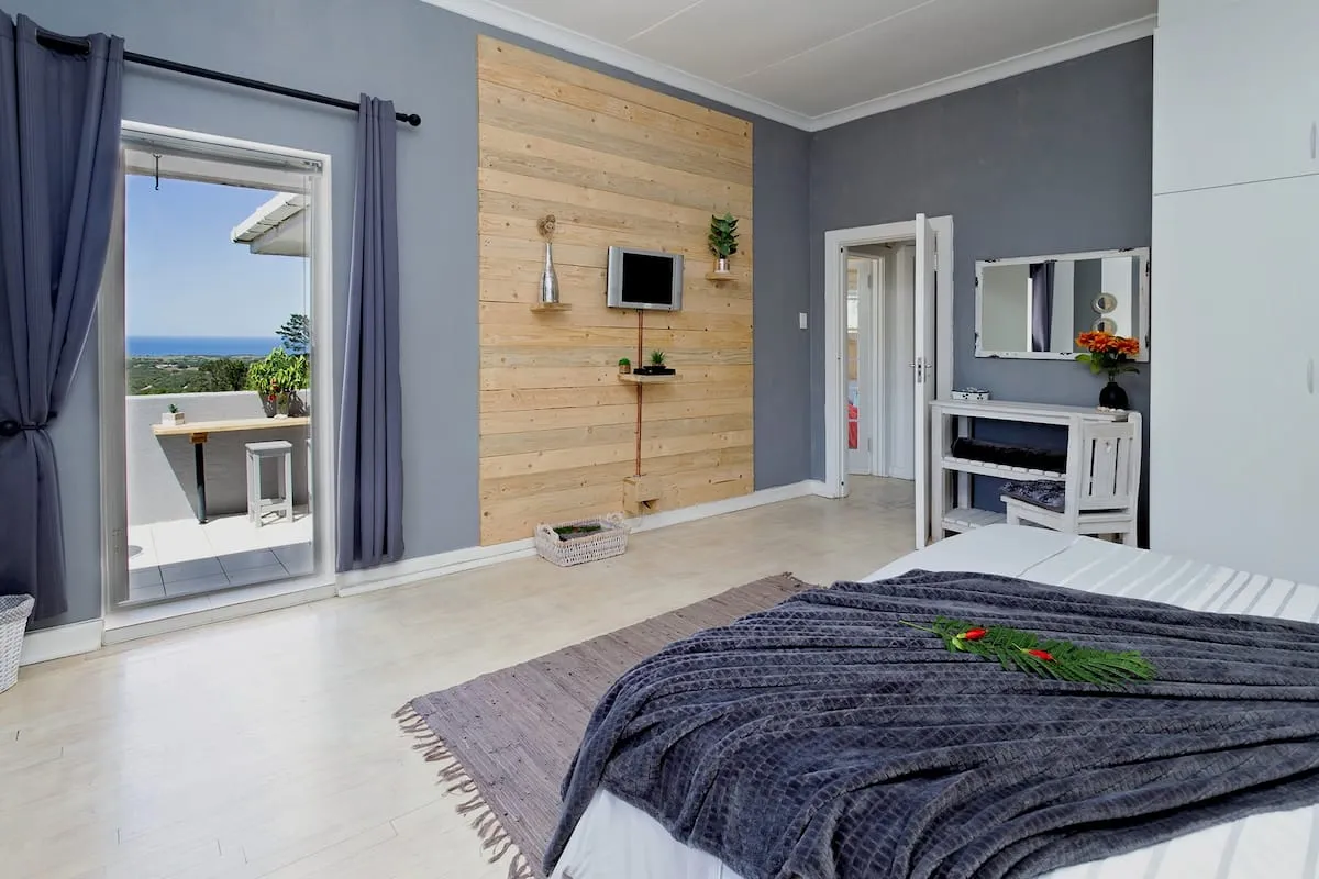 Modern bedroom with ocean view wooden wall and large window