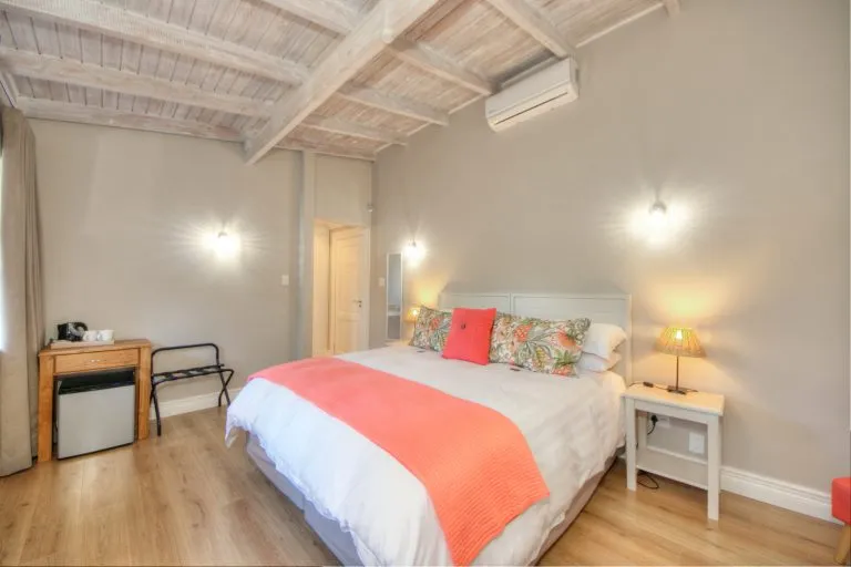 Cozy bedroom with a large bed wooden floor and modern decor