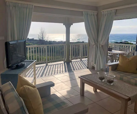 Living room with ocean view TV and outdoor seating area
