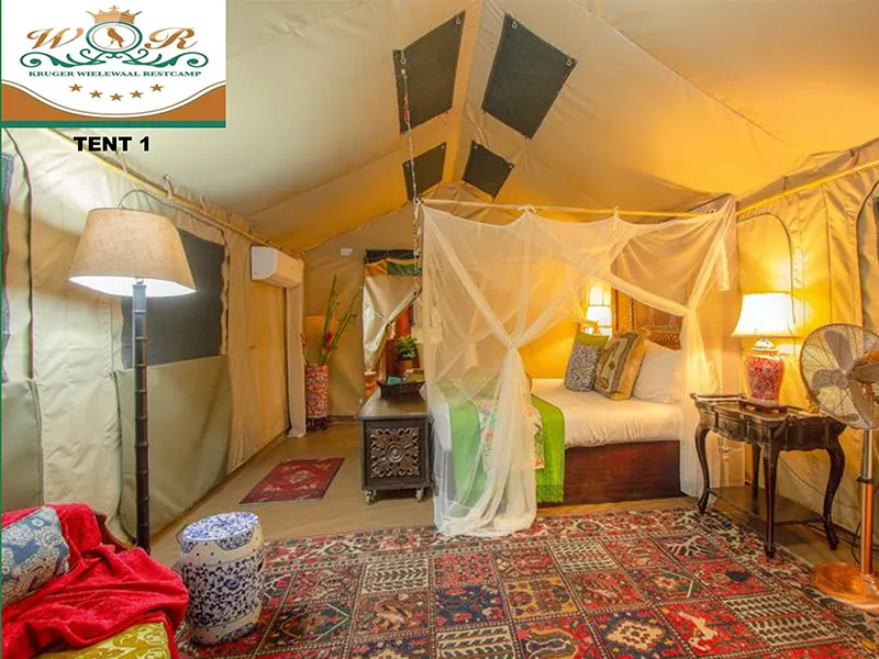 Luxury tent interior with bed lamps and patterned rug