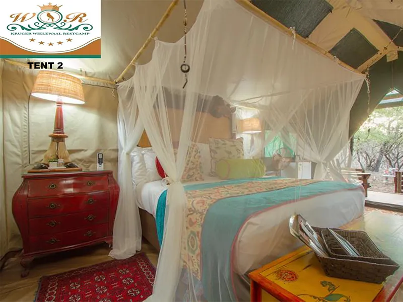 Luxury tent interior with a bed canopy and vibrant decor