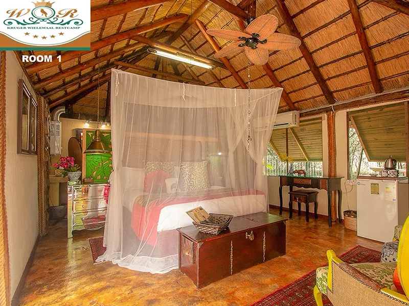 Cozy bedroom with a large bed mosquito net and wooden ceiling