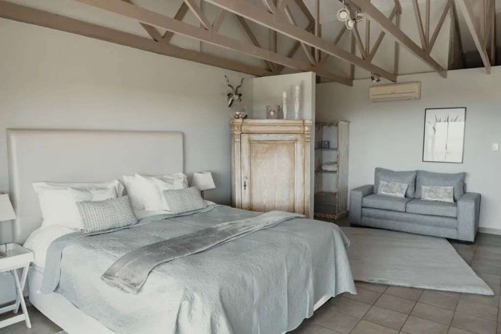 Cozy bedroom with a large bed sofa and wooden wardrobe
