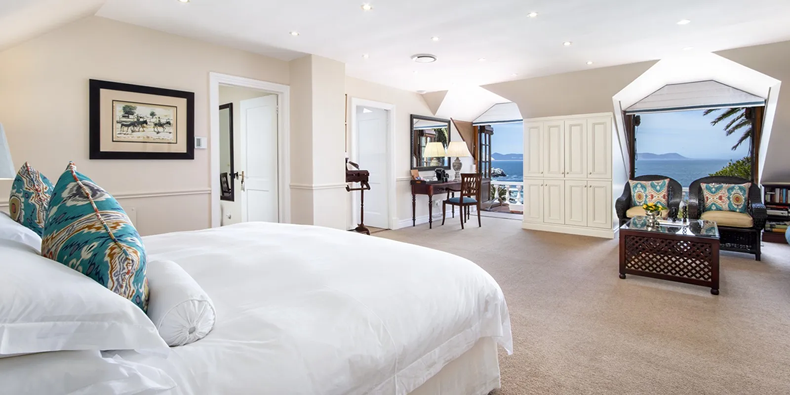 Luxurious bedroom with ocean view large bed and seating area