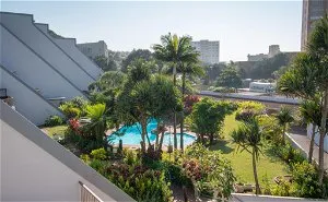 Swimming pool surrounded by tropical plants in a residential area
