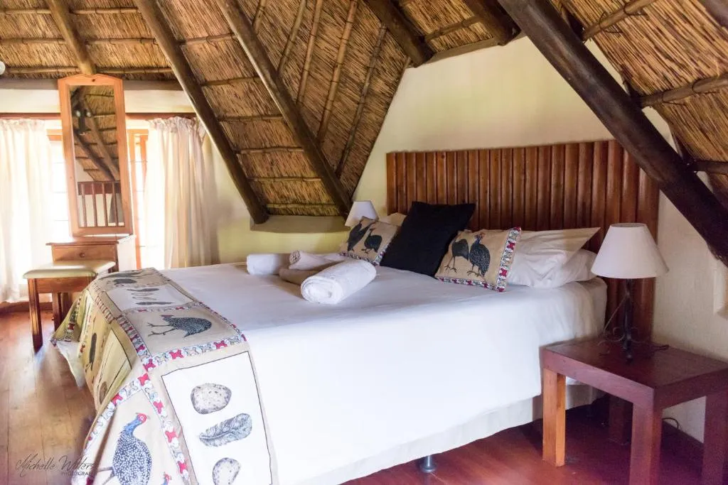 Cozy bedroom with a large bed wooden ceiling and bedside tables with lamps