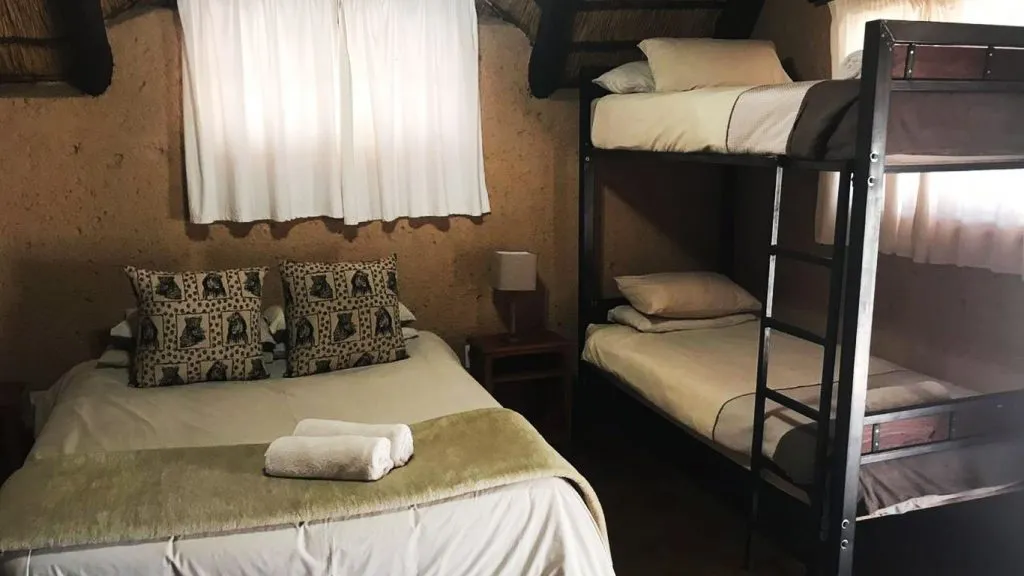 Cozy bedroom with a double bed and a metal bunk bed