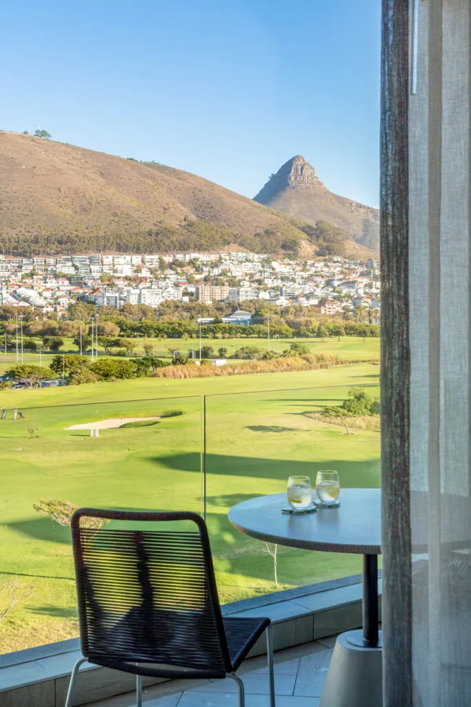 Chair and table with mountain view through a window