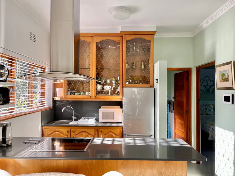 Modern kitchen with wooden cabinets stainless steel appliances and a large window