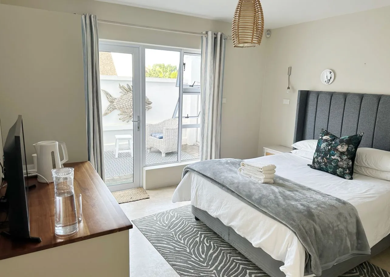 Bedroom with large bed sliding door to patio and wooden bedside table