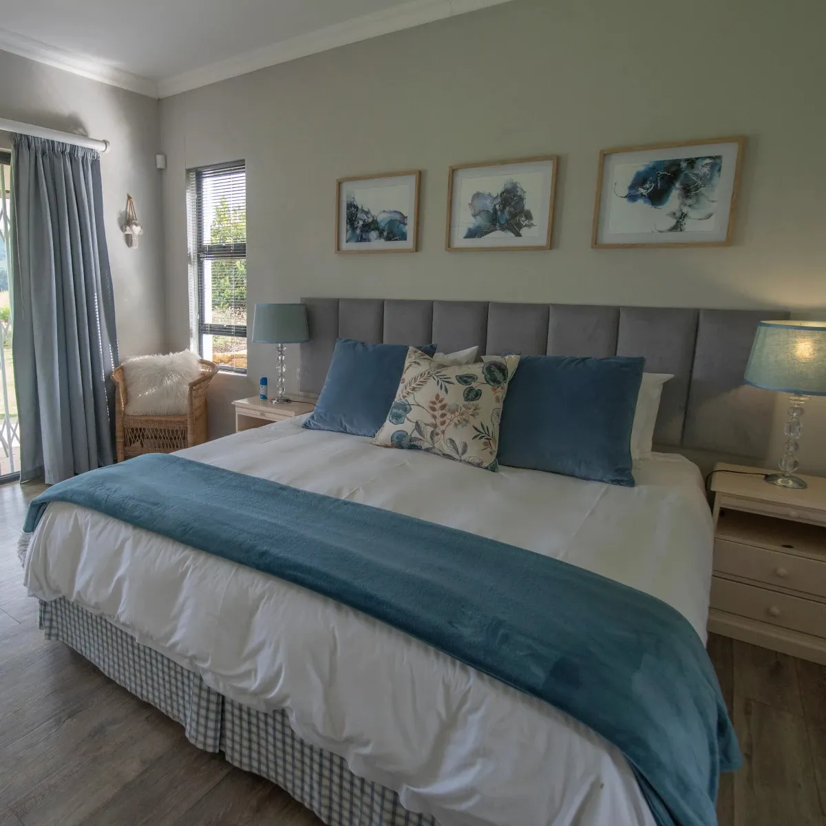 Cozy bedroom with a large bed blue accents and bedside tables with lamps