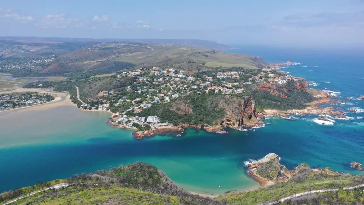 Coastal town with colorful buildings on cliffs overlooking turquoise ocean waters