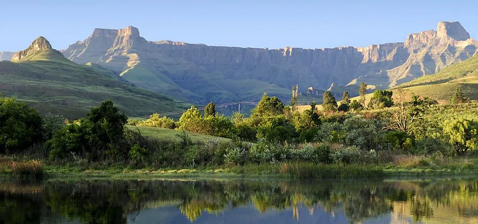 Majestic mountains with lush greenery reflected in a calm lake