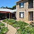 Pathway through a garden leading to a brick building with windows