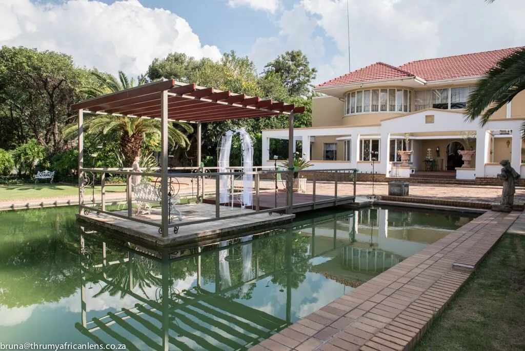 Modern house with a pool and a wooden pergola over the water