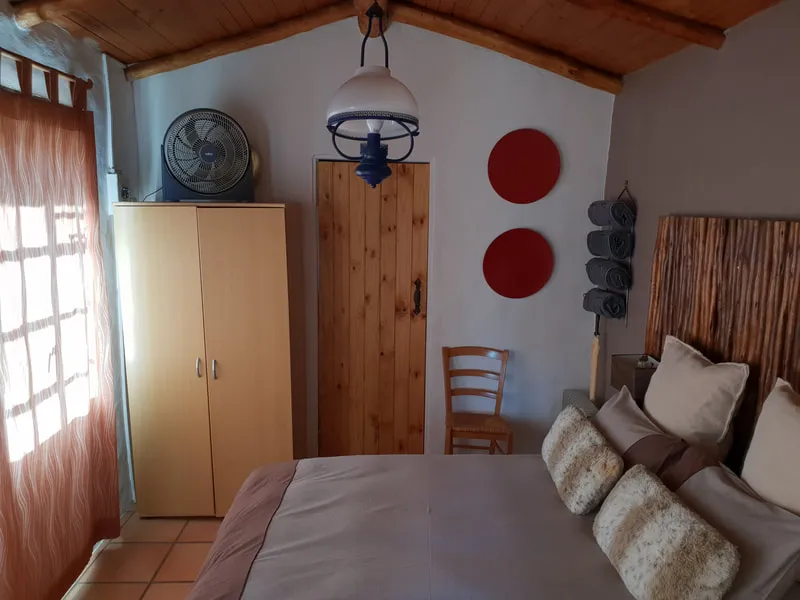 Cozy bedroom with wooden furniture a bed and a ceiling fan