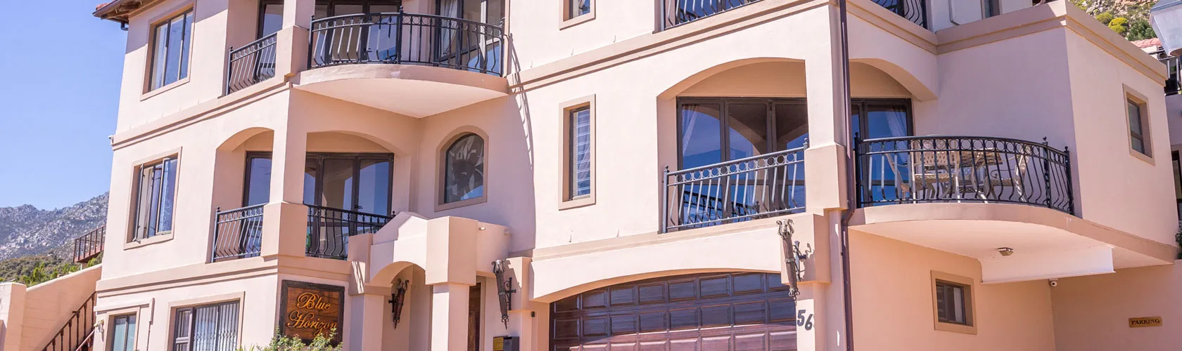 Modern multistory building with balconies and large windows in a sunny location