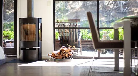 Modern living room with a woodburning stove and large windows