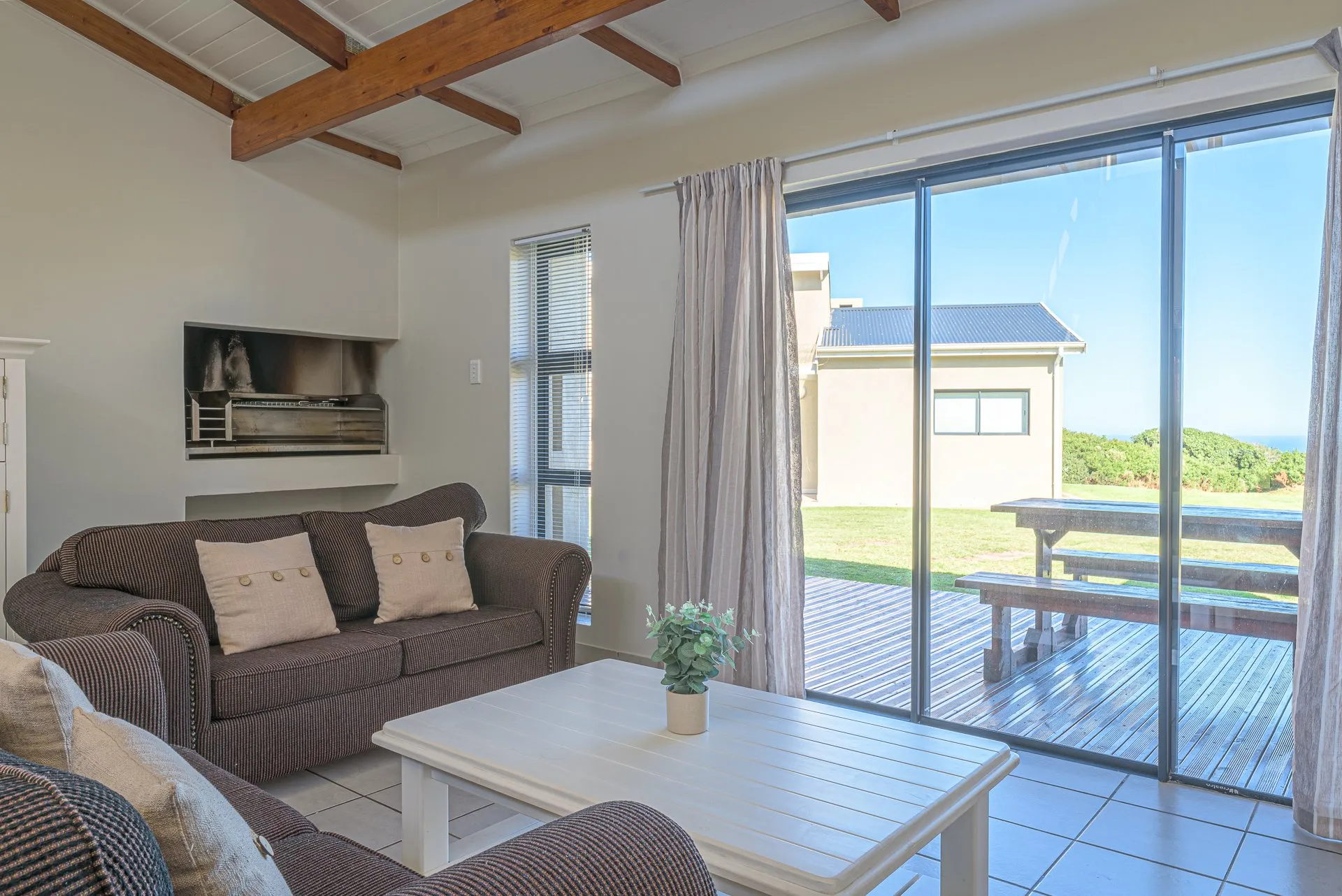 Cozy living room with sofa coffee table and large sliding glass doors