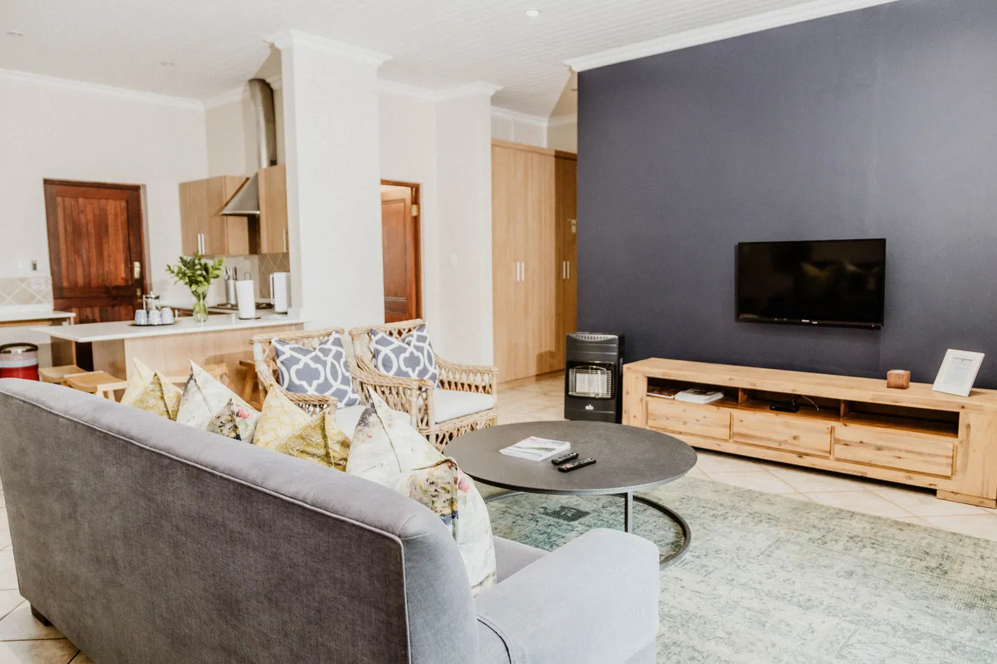 Modern living room with grey sofa TV and wooden furniture