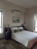 Neat bedroom with double bed nightstands lamps and a framed painting