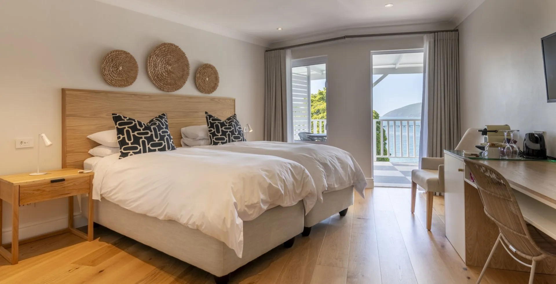 Bedroom with two beds wooden decor and a view of a balcony