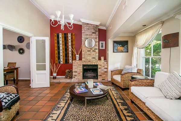 Cozy living room with fireplace wicker chairs and patterned rug