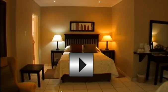 Cozy bedroom with a bed nightstands lamps and a mirror