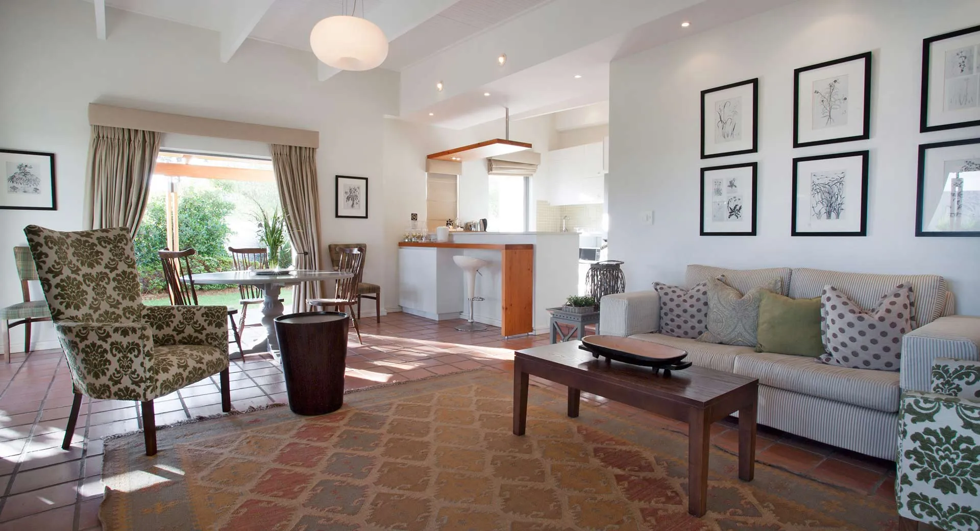 Cozy living room with sofa armchair coffee table and open kitchen view