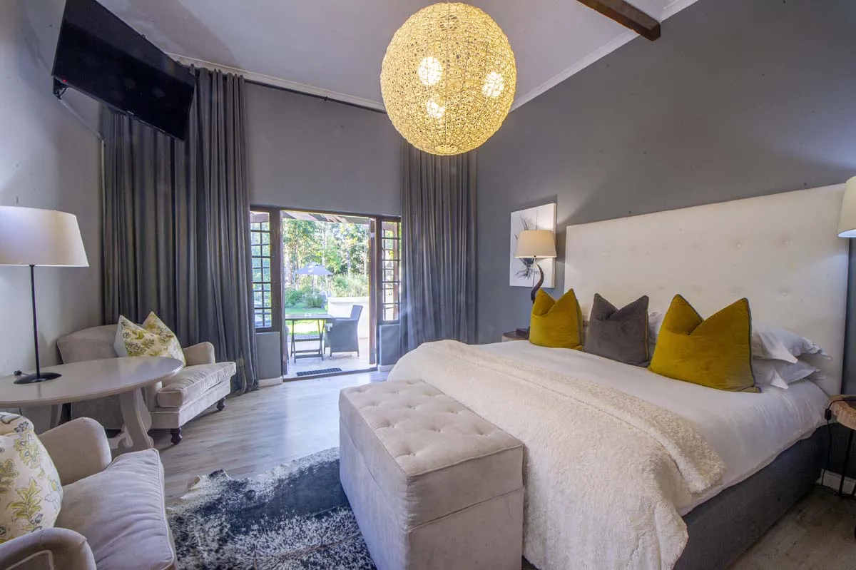 Modern bedroom with large bed gray walls and open patio view