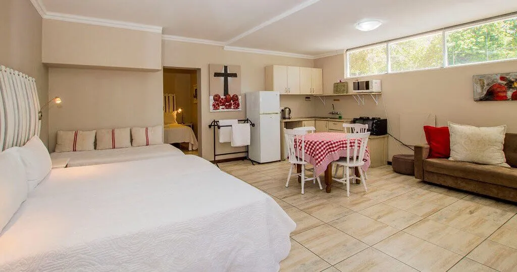 Studio apartment with bed kitchenette dining table and sofa