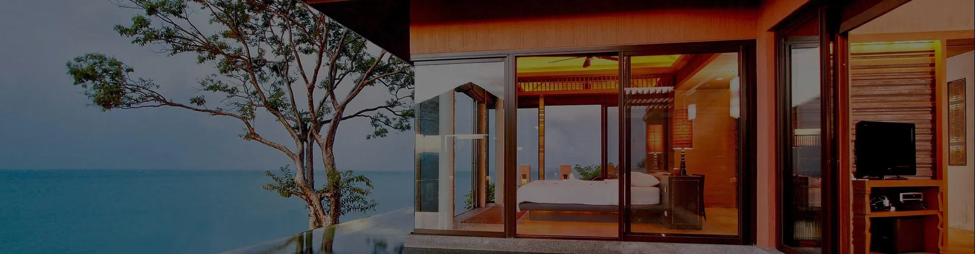 Modern beachfront room with large windows and ocean view